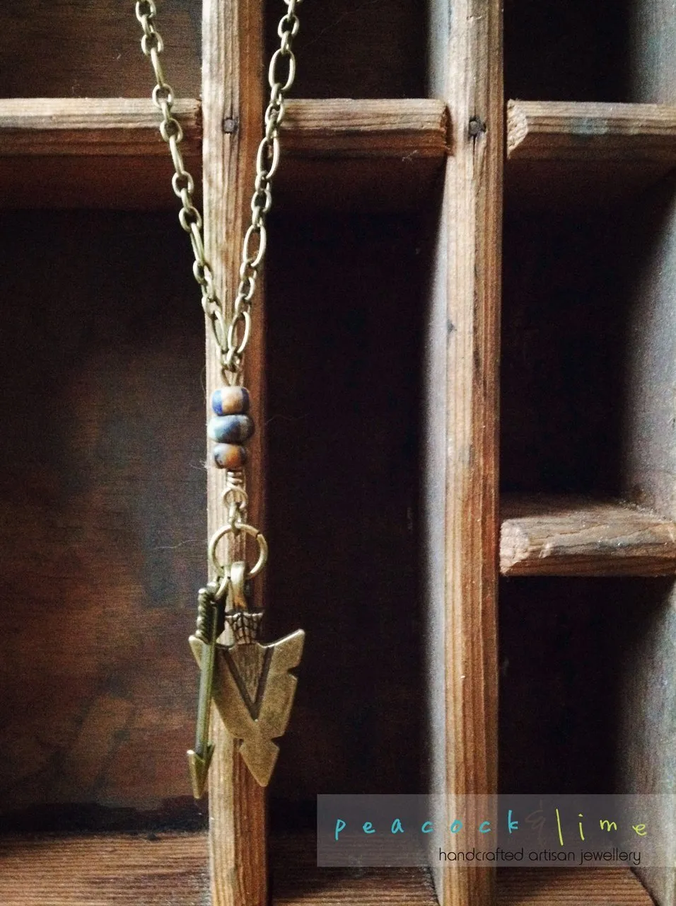 tribal arrowhead and arrow long brass necklace