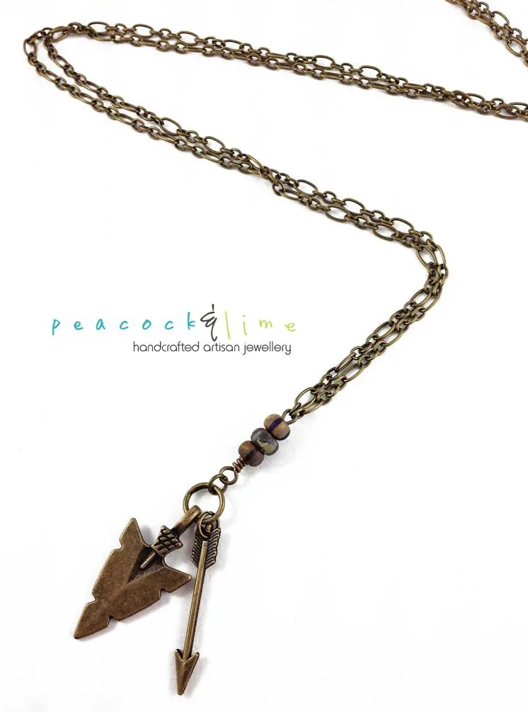 tribal arrowhead and arrow long brass necklace